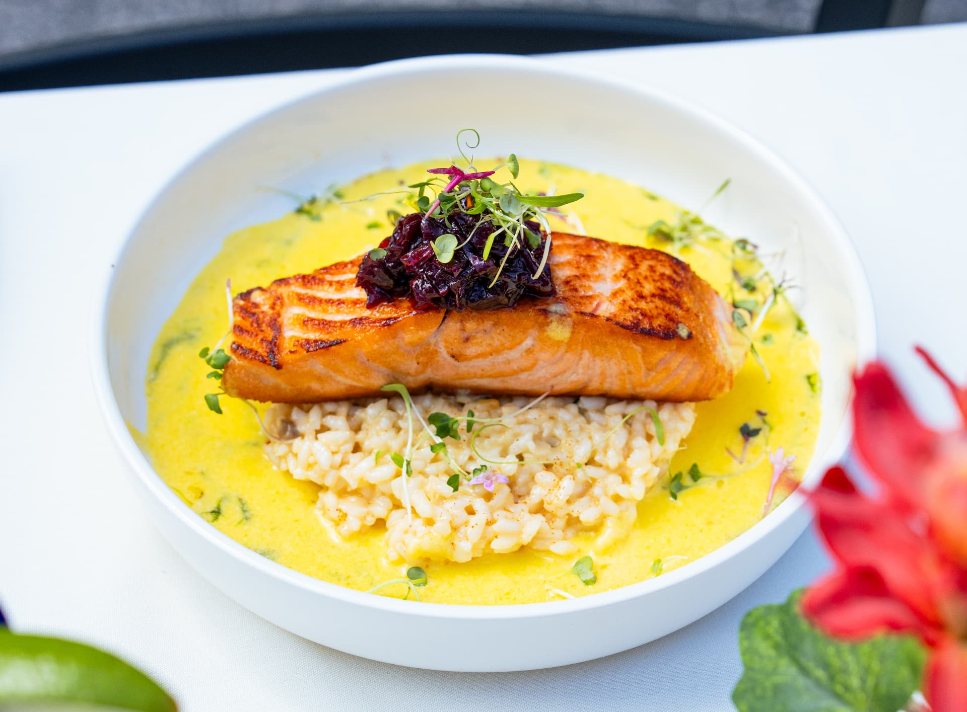 Seared salmon fillet over risotto in a saffron cream sauce
